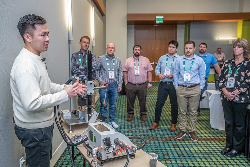 man demonstrating technology to event attendees
